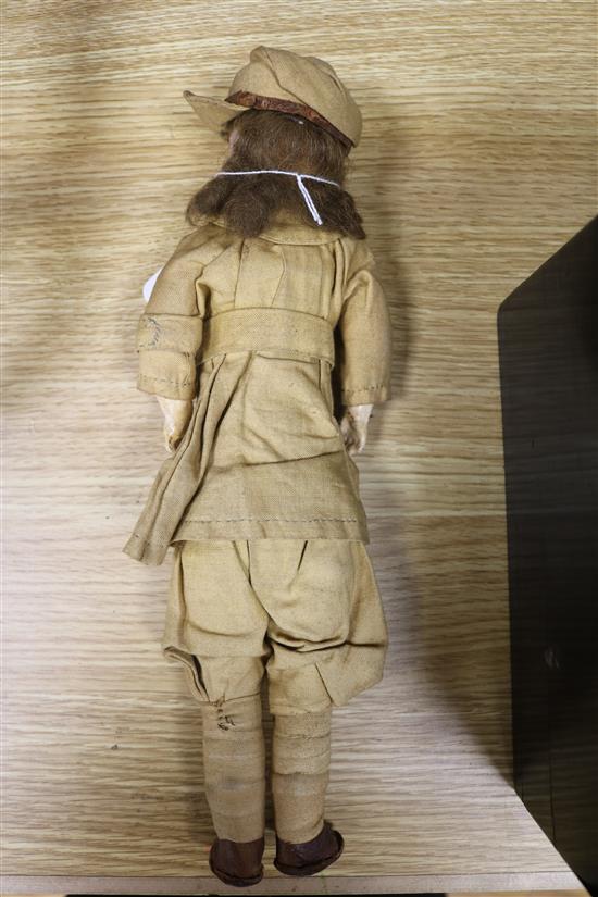 A French bisque head doll dressed in WWI army uniform length 33cm